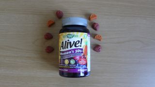 Container of Nature's Way Alive! Women’s 50+ Gummy Multivitamin laid on a table
