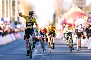 Tiesj Benoot celebrates Kuurne-Brussel-Kuurne victory as teammate Nathan Van Hooydonck sprints to second in the background