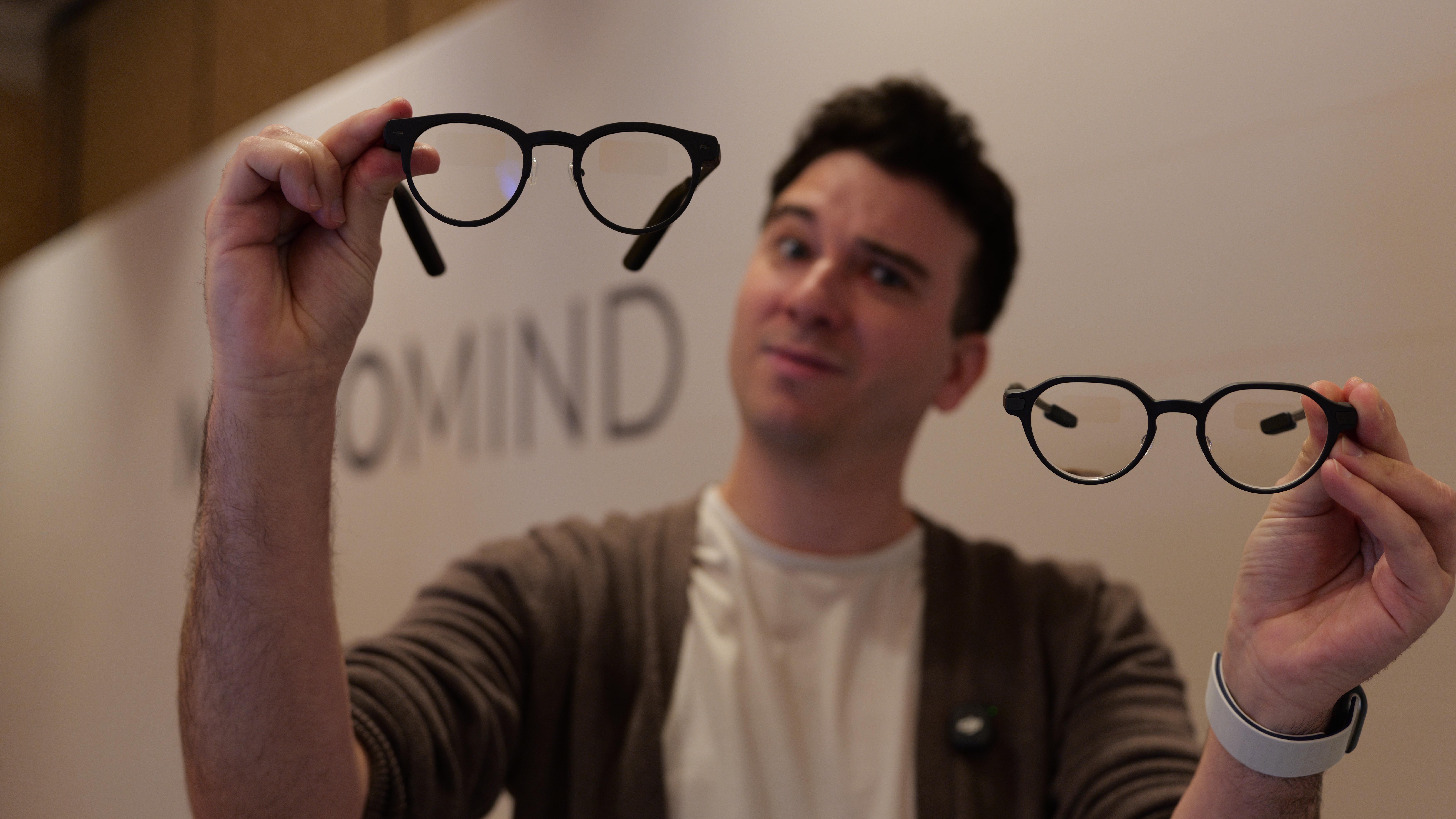 MemoMind One smart glasses in hand