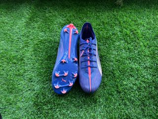 Puma Ultra 5 Ultimate football boots placed on a piece of astro turf for reviewing