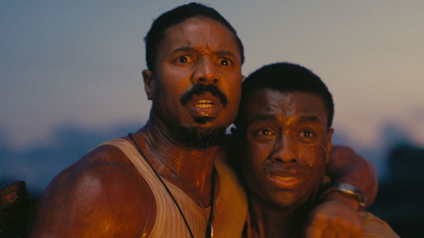 Michael B Jordan and Miles Caton stand scared as they&#039;re bathed in firelight in Sinners.