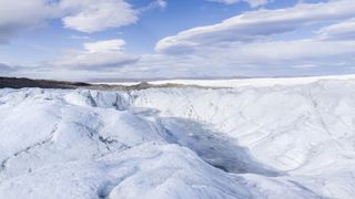 The Greenland ice sheet is a vast body of ice covering 660,000 square miles (1,710,000 square kilometres), roughly 80% of the surface of Greenland.