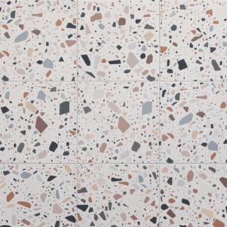 A white tile with colorful terrazzo patterns on it