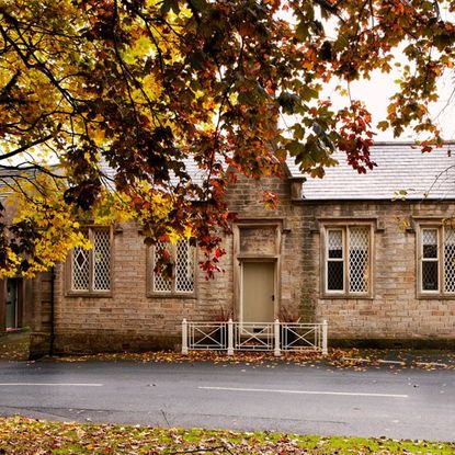 cosy home with the first leaves to fall surrounding its exterior