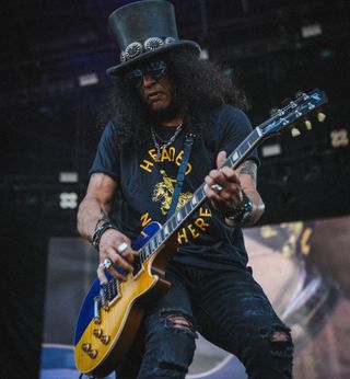 Slash plays a custom Gibson Les Paul sporting the colors of the Ukrainian flag onstage