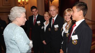 Queen Elizabeth II meets the Olympic diving team including Tom Daley (R) at a reception held at Buckingham Palace in 2008