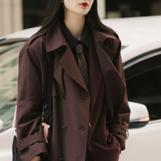 Woman wearing brown coat, brown tie, and red lip during Tokyo Fashion Week.