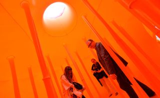 People standing in an orange room