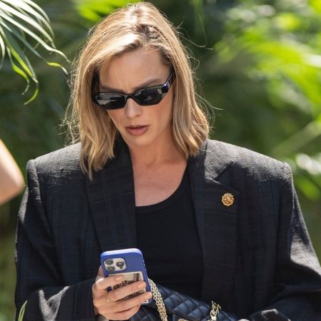 Margot Robbie wore black jeans instead of the white jeans trend, with Chanel pumps