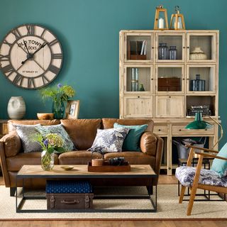 living room with teal green wall and wooden flooring