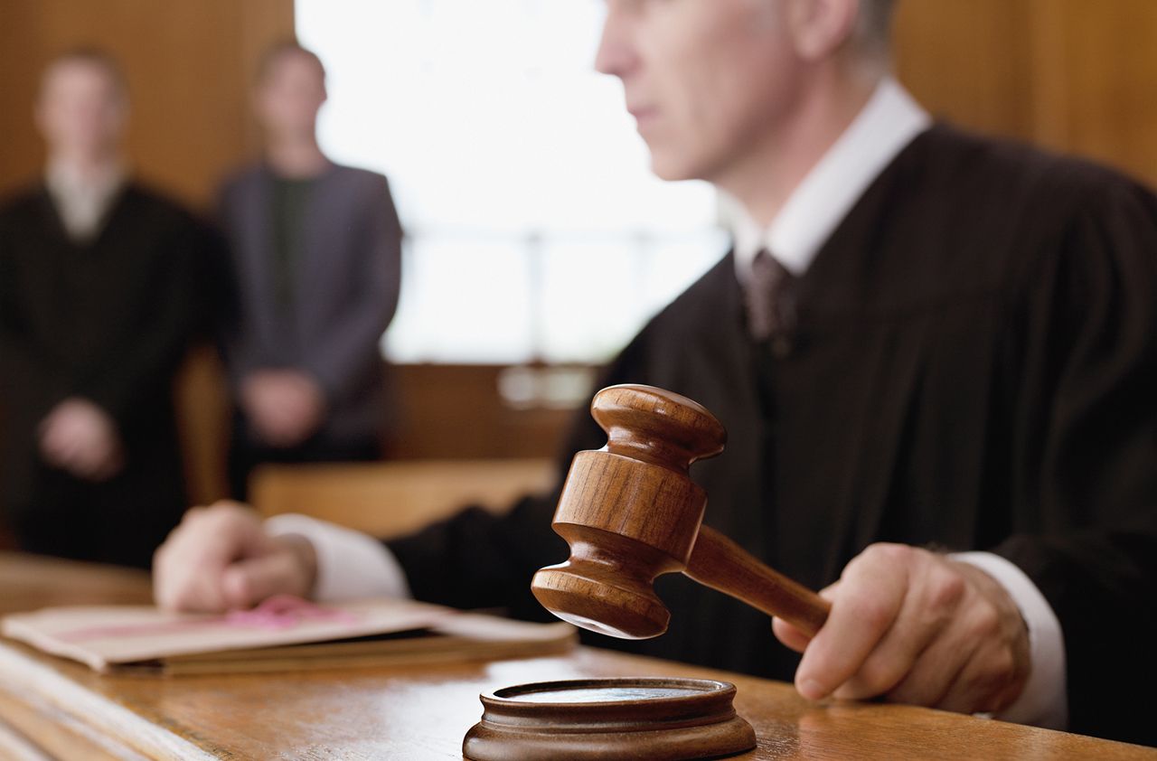 Judge holding gavel in courtroom