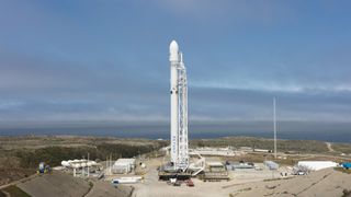 A SpaceX Falcon 9 rocket stands on the company's launch pad at Vandenberg Air Force Base in California ahead of the Iridium-2 mission in June 2017. A similar Falcon 9 rocket will launch 10 Iridium Next communications satellites into orbit from the same pa
