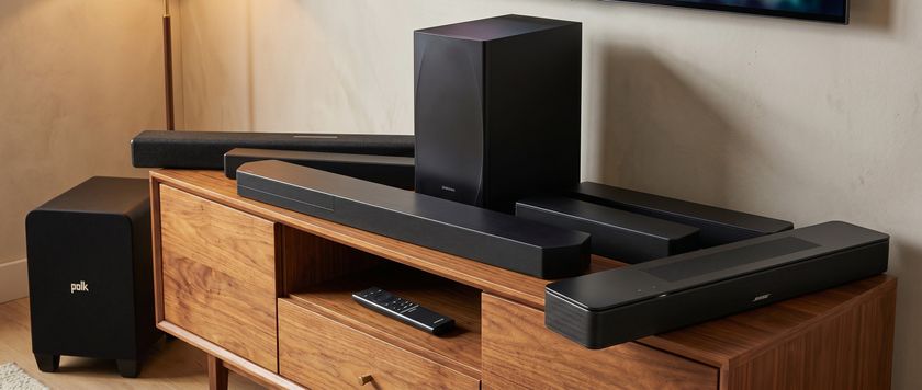 an image of the samsung q600f, qs750f, hw-b650, polk audio signa s4, sony ht-s100f, and bose smart soundbar on a living room cabinet