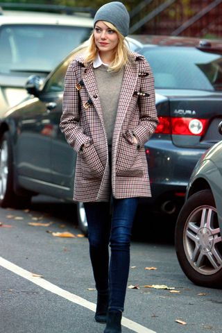 Emma Stone keeps warm in a cosy coat and beanie hat