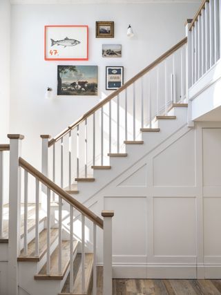 white staircase with gallery wall