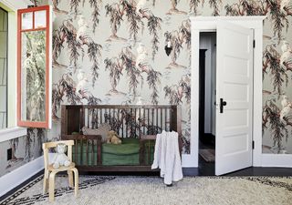 nursery with House of Hackney Zeus wallpaper, wooden crib, textured rug, kids chair