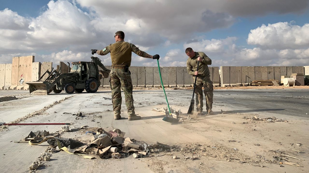 U.S. military personnel clean up at al-Asad air base in western Iraq