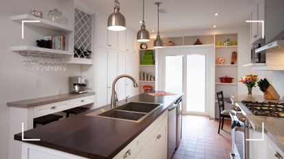 white kitchen with sink island unit and clever kitchen storage idea built around the French Doors