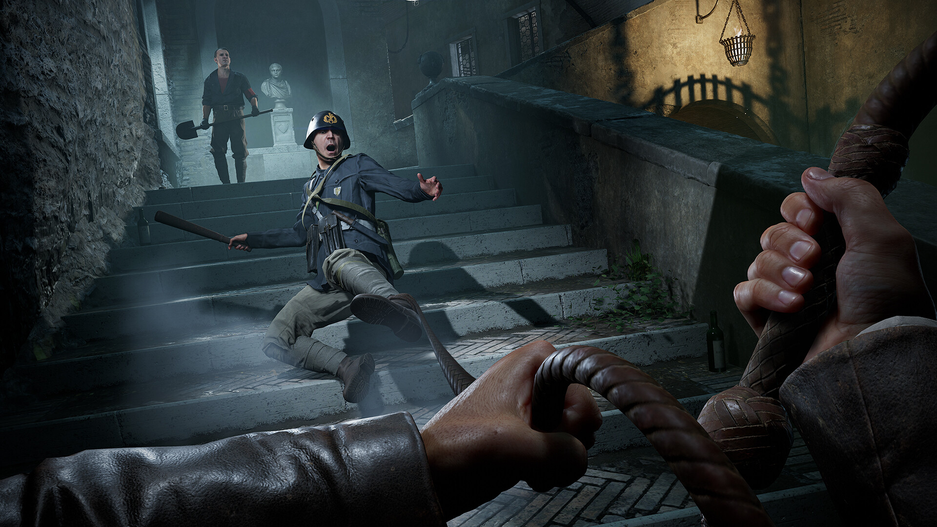 Indiana Jones and the Great Circle screenshot showing Indiana Jones using his whip to pull a soldier down a flight of stone steps, while another man with a shovel follows him