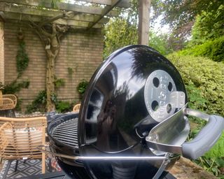 Weber Smokey Joe bbq with hinged lid on in garden