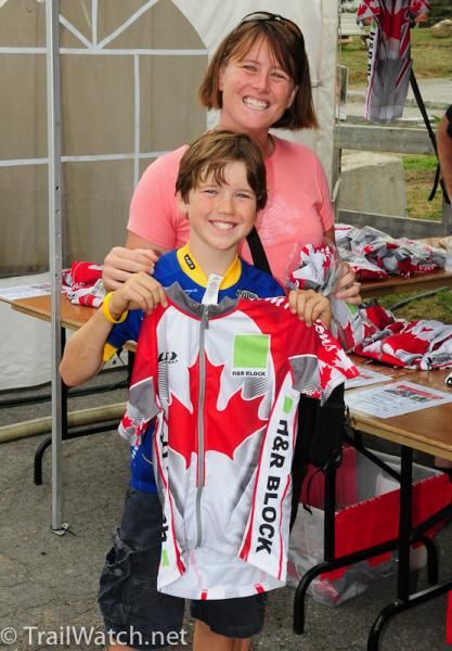 A young boy buys a race jersey with hopes that his favorite riders will autograph it.