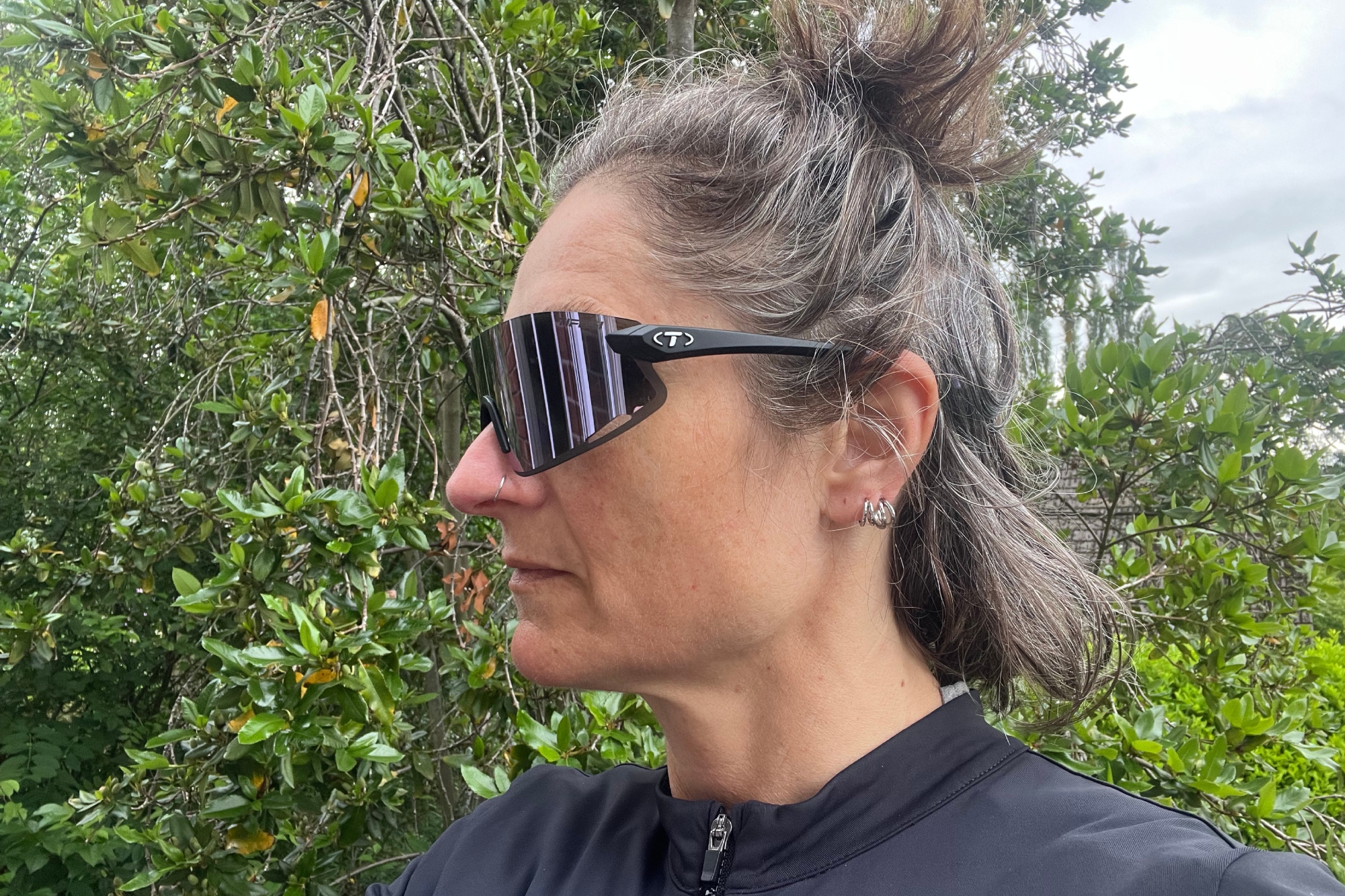 Hannah Bussey with the Tifosi Vogel XC Sunglasses on shown to the side with greenary in the background