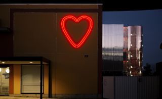 Neon heart on the façade of the gallery.