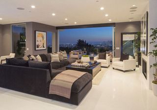 living area with black sofa and arm chair