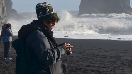 A person holding a Fujifilm X-T50 mirrorless camera