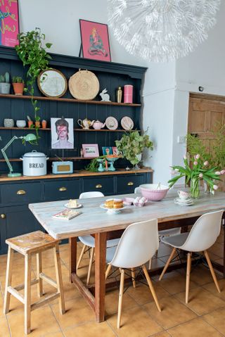 kitchen with dark painted dresser and salvaged table