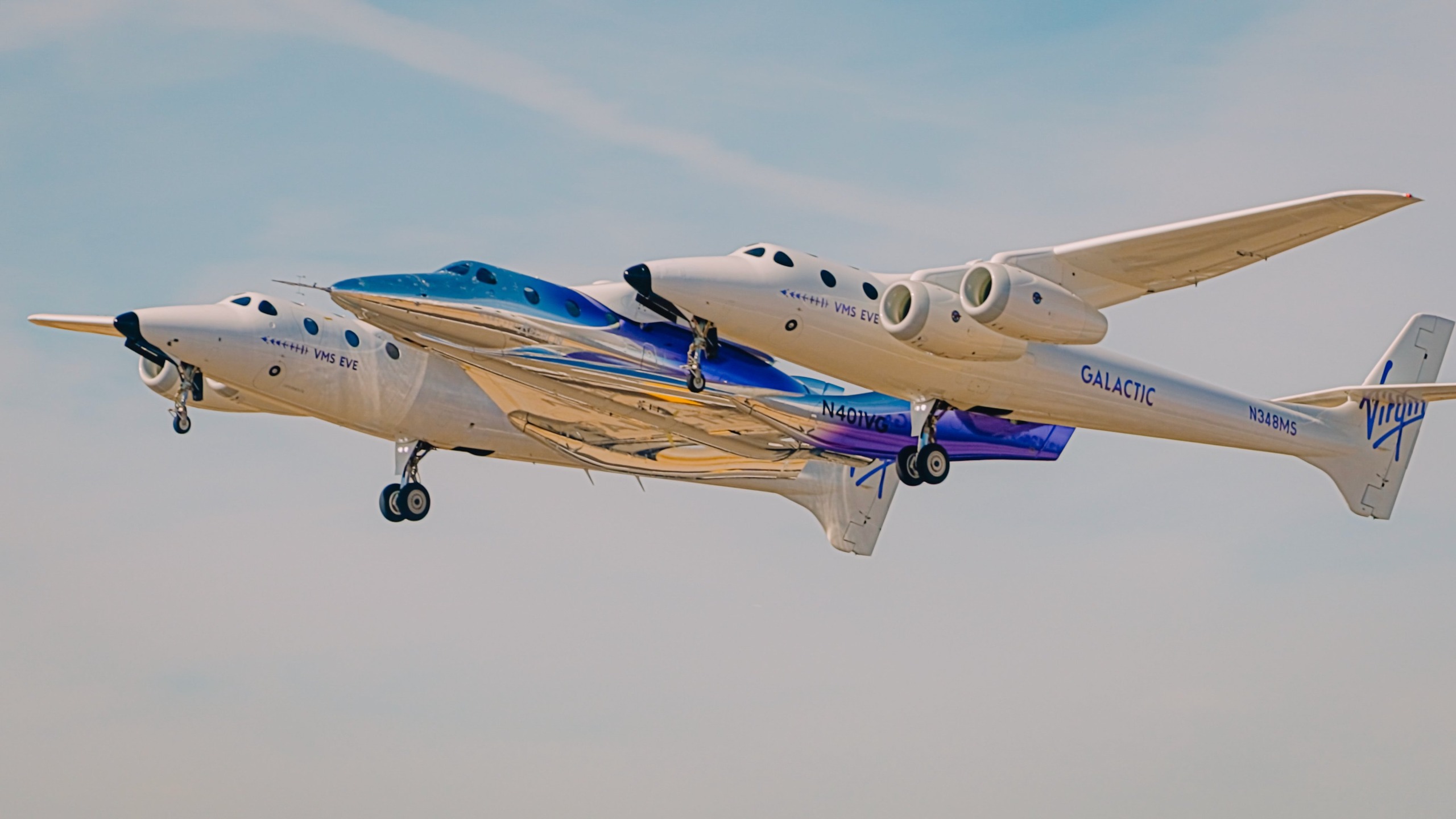 Virgin Galactic's first Delta-class space plane, named Apeiron, takes to the skies for the first time on Oct. 28, 2026, beneath the wings of its carrier plane, VMS Eve.