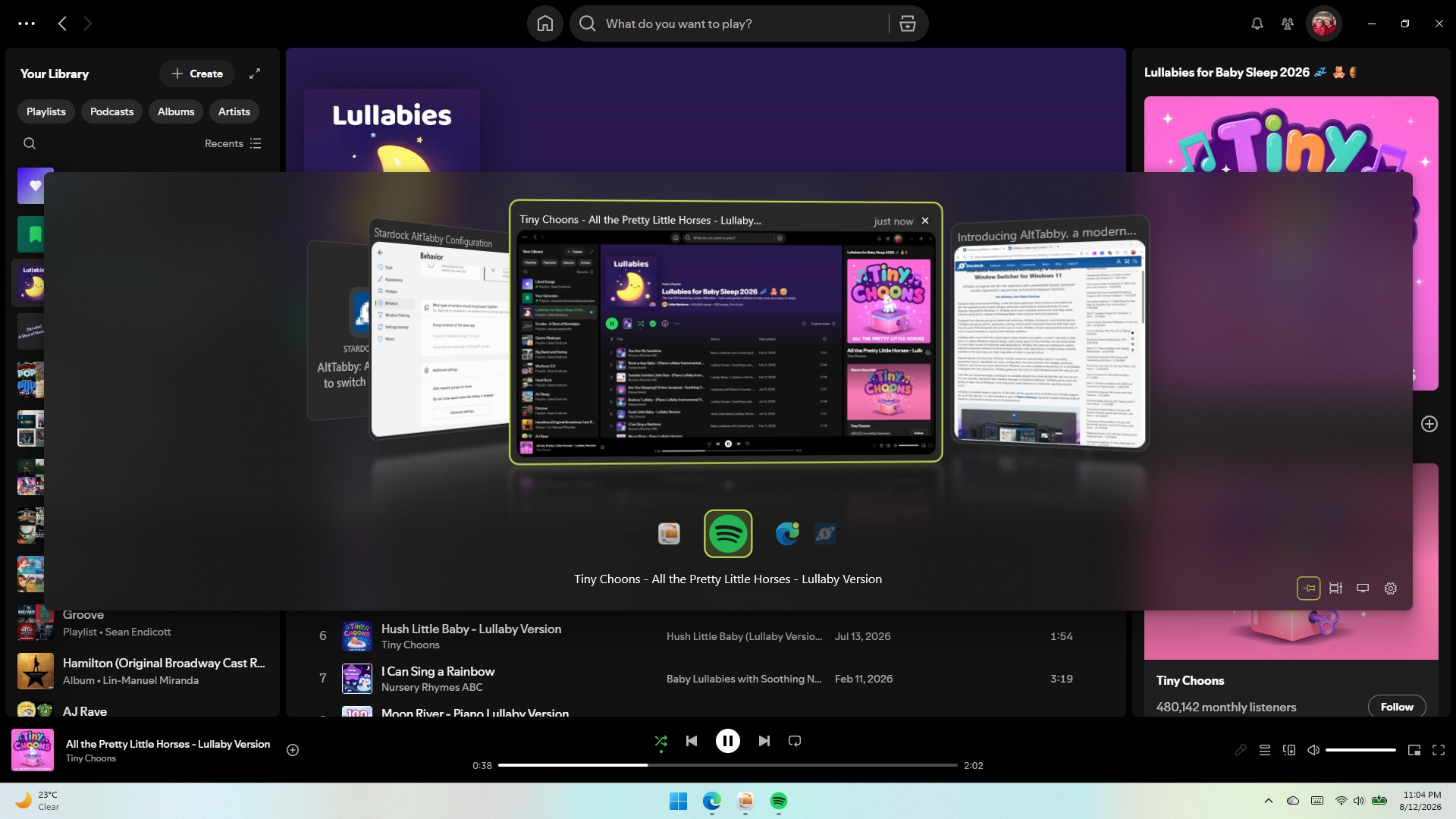 Screenshot of the AltTabby app switcher overlay on top of Spotify, displaying live window previews of open applications in a curved 3D carousel layout.
