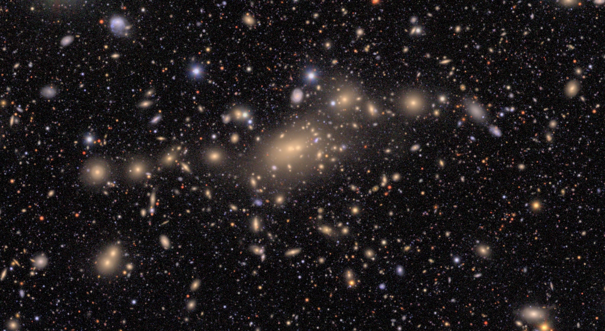 an image of a cluster of glowing orange galaxies in space