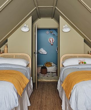 twin attic bedroom with matching dressed beds and green walls