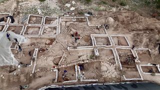 An aerial photo showing many rectangular rooms of a sprawling excavated building