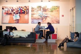 The charity: water team working hard on couches, in bean bag chairs and in our custom-built cafe booth