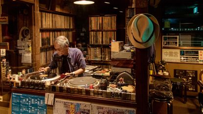Man at turntable, image from tokyo jazz joints book from kehrer verlag