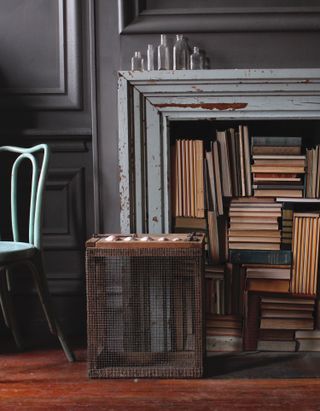 Disused fireplace filled with books
