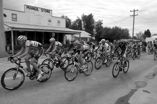 Riders pass the general store at Piangil near Nyah on the short-and-sweet 56.9 kilometre seventh stage.