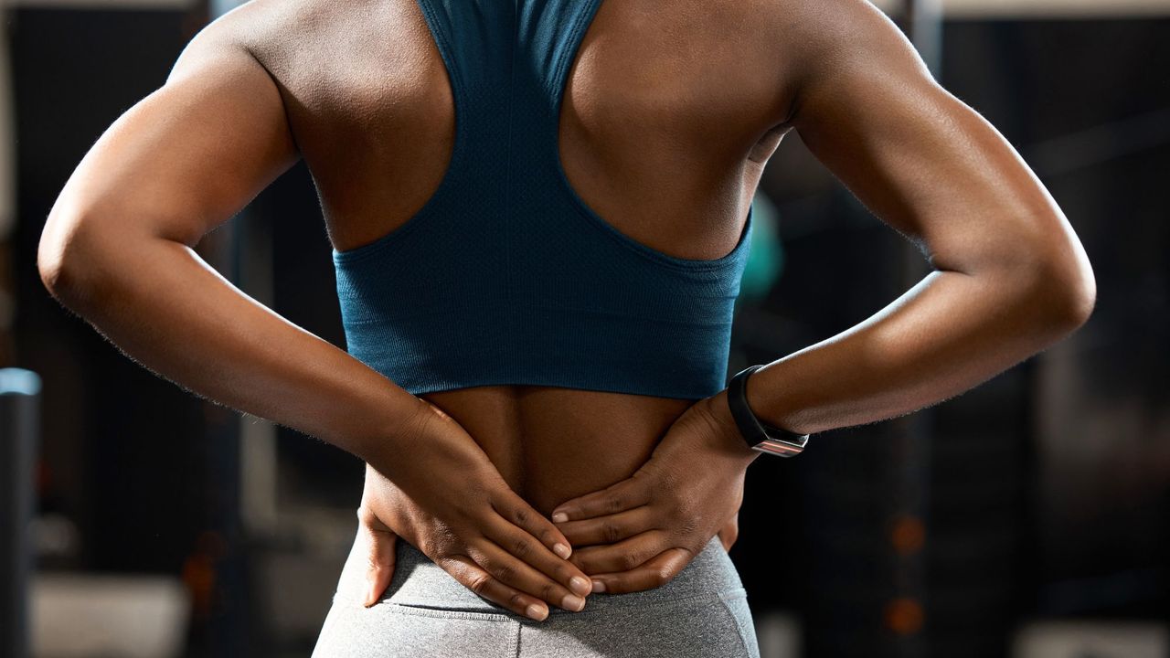 Nervous system regulation: A woman stretching her back wearing sports gear