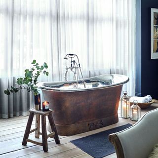bathroom with cooper bathtub and shower
