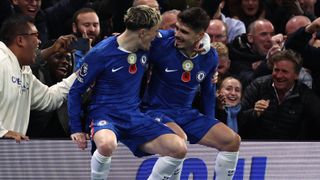 TOPSHOT - Chelsea's Portuguese midfielder #07 Pedro Neto (R) sits on the advertising boards with Chelsea's Argentinian midfielder #19 Alejandro Garnacho (L) as he celebrates scoring their third goal for 3-0 during the English Premier League football match between Chelsea and Wolverhampton Wanderers at Stamford Bridge in London on November 8, 2025.