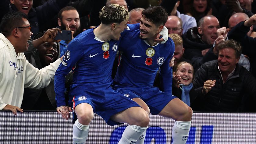 TOPSHOT - Chelsea&#039;s Portuguese midfielder #07 Pedro Neto (R) sits on the advertising boards with Chelsea&#039;s Argentinian midfielder #19 Alejandro Garnacho (L) as he celebrates scoring their third goal for 3-0 during the English Premier League football match between Chelsea and Wolverhampton Wanderers at Stamford Bridge in London on November 8, 2025.