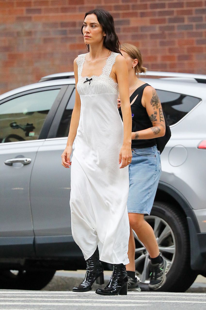 Alexa Chung wearing a white maxi dress with patent leather knee boots in NYC