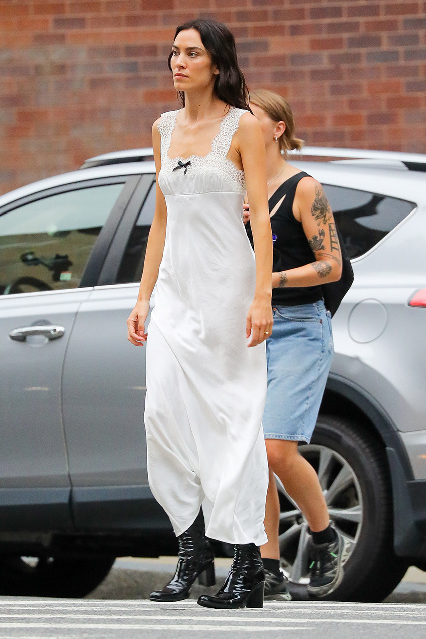 Alexa Chung wearing a white maxi dress with patent leather knee boots in NYC