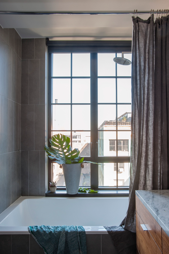 Bathroom with large bath tub and window