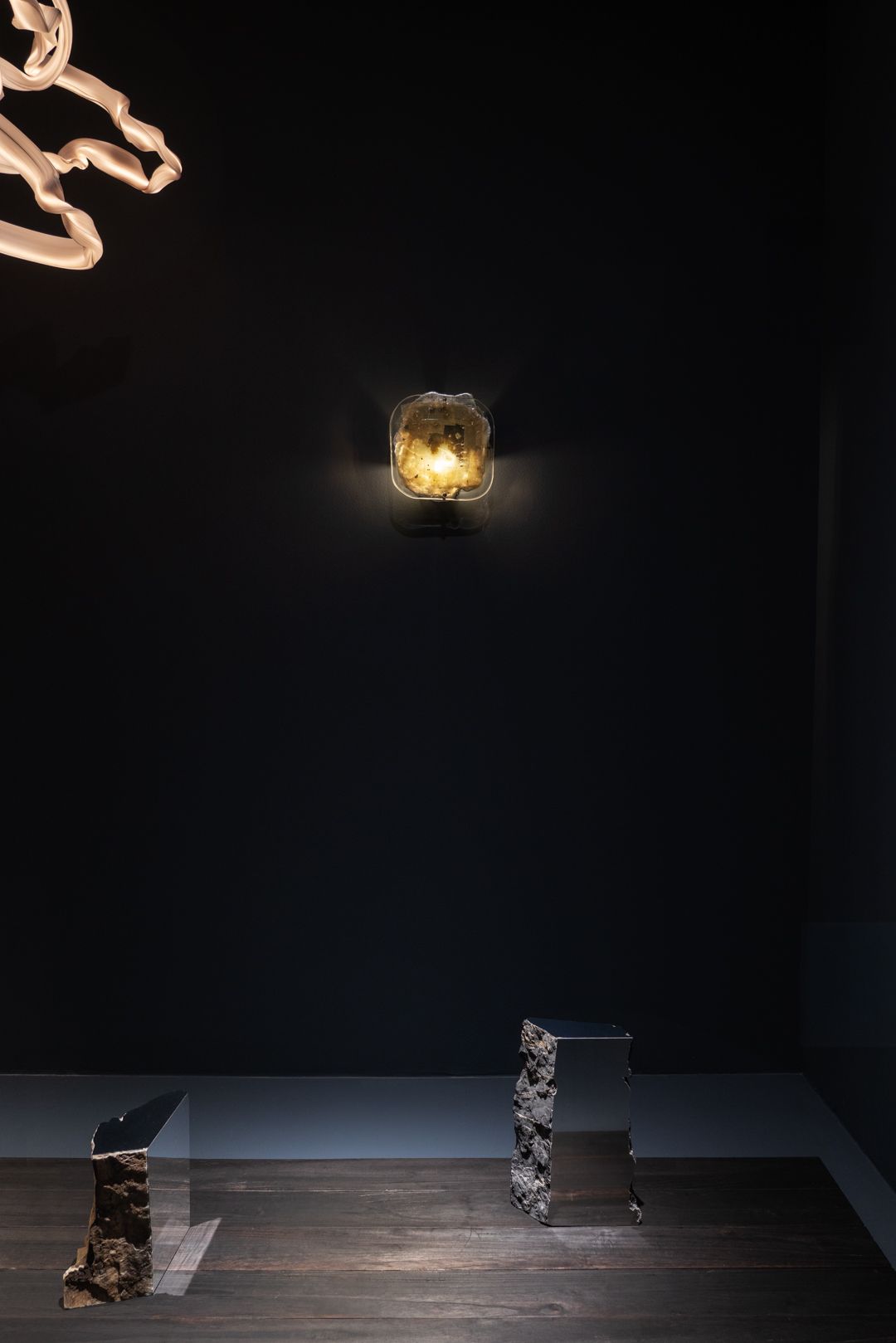 artwork displayed in black gallery space