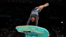 Simone Biles launches upside-down off of the vault