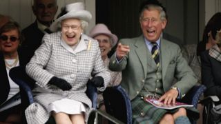 Queen Elizabeth II and Prince Charles, The Prince of Wales laugh as they watch competitors during the Braemar Gathering