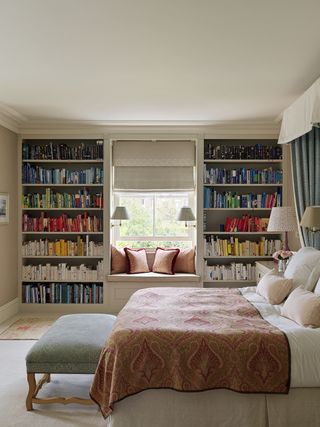 bedroom with window seat and lots of books